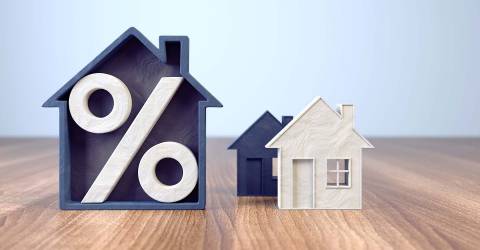 Houten huizen met een procentteken